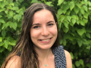 Journalist Karli Goldenberg, a smiling fair-skinned woman with long dark hair