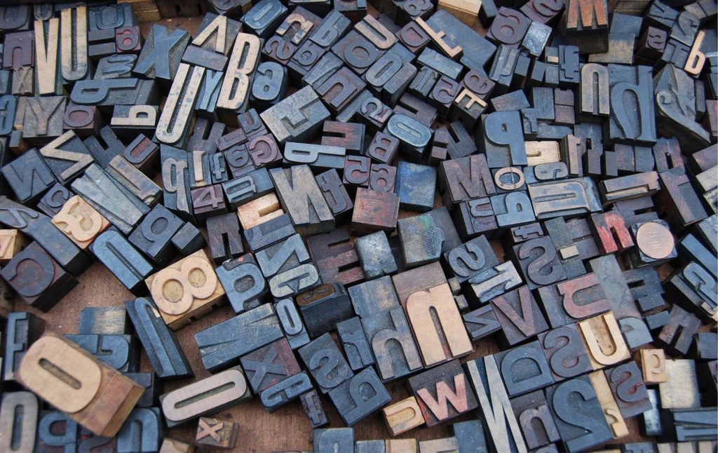 A tray of old printer's woodblocks, image sourced via Pixabay, Creative Commons CC0