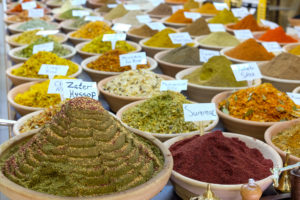 Heaped bowls of spices at a market