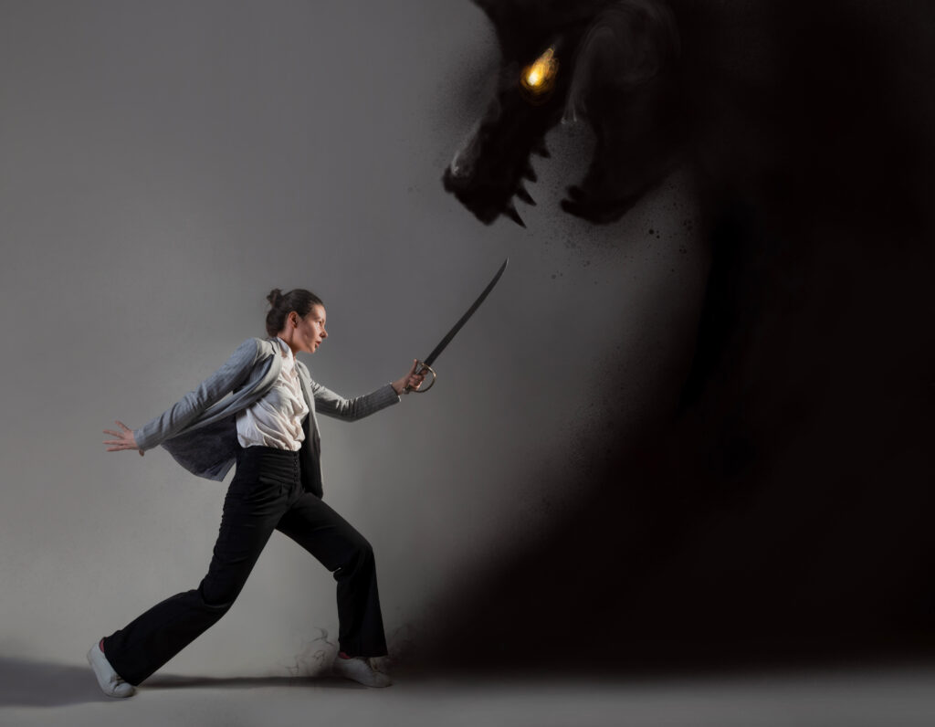 Stock art of a female-looking person stabbing a shadow dragon with glowing yellow eyes. She's racing towards it, holding a sword, while wearing business casual.